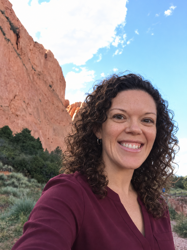 Melanie Black smiling outdoors at Garden of the Gods, Colorado